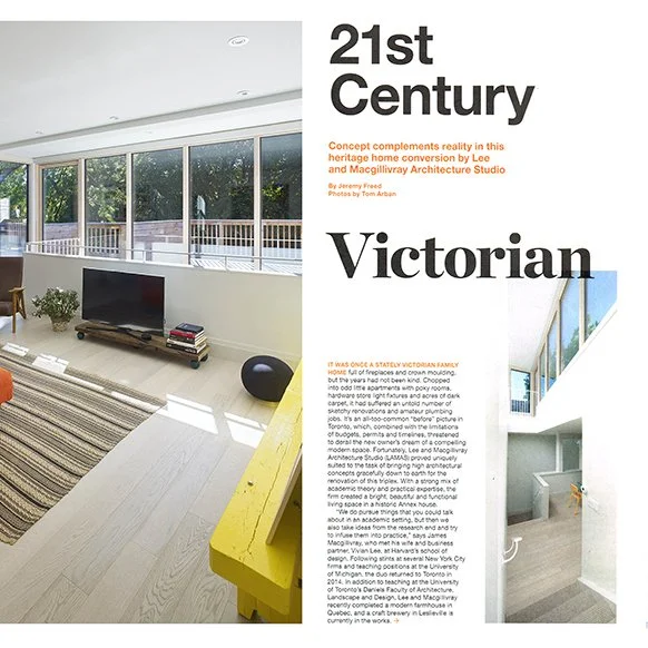 Interior view of a house with large windows, a staircase, a TV on a stand, and a yellow table.