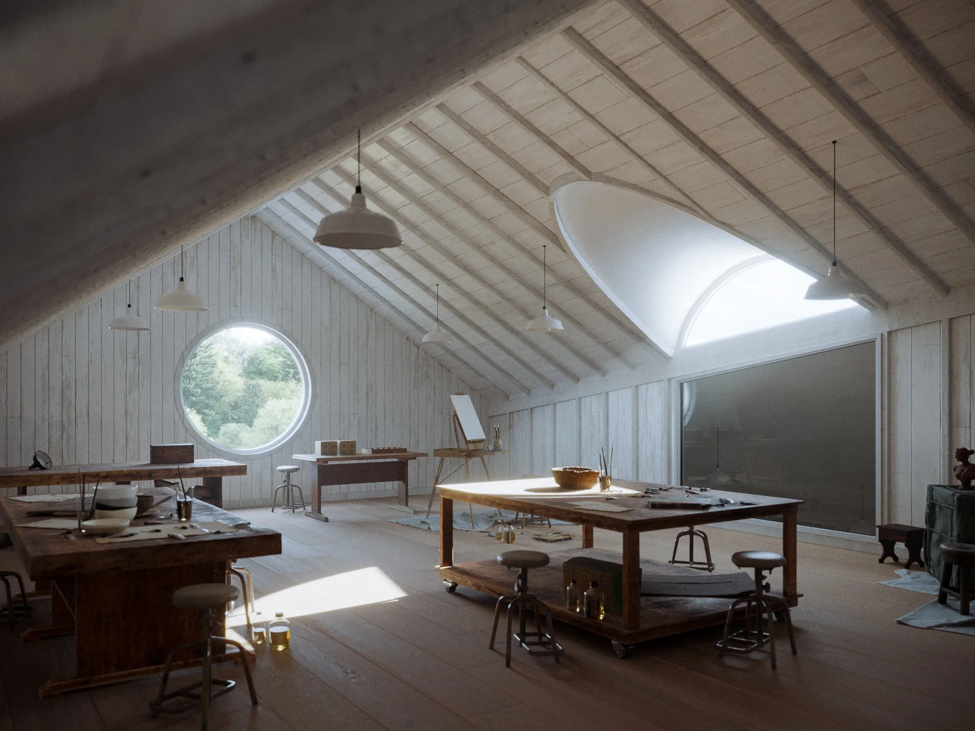 A spacious attic room with a sloped wooden ceiling and large windows, including a circular window with a view of trees and a skylight. The room contains wooden tables, chairs, and art supplies, with natural light illuminating the space.
