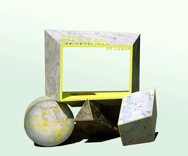 Modern jewelry display with geometric shapes and a mirror, featuring a marble pattern and yellow accents.