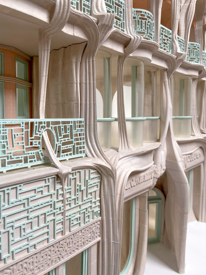 Close-up of an architectural design with curved, organic shapes and intricate blue latticework on balconies.