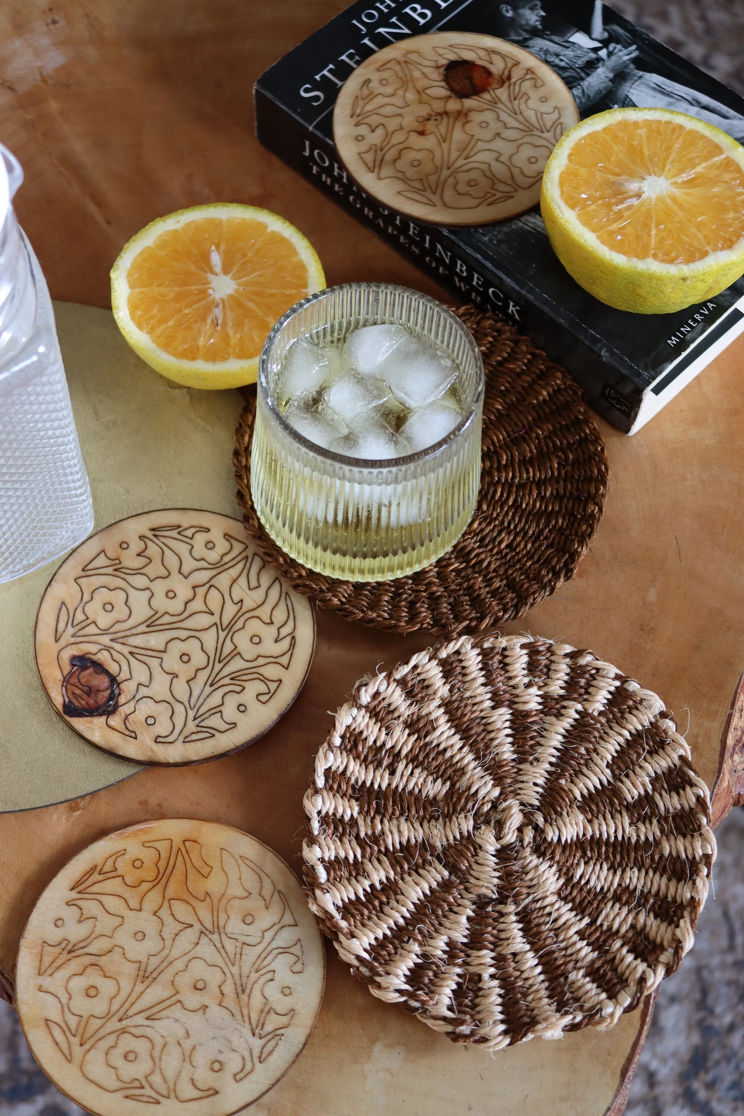In Picture:
Patterned Sisal Mini Coaster in sand and chocolate- Diameter: 5 Inches
Wooden coasters with flower art and a smooth finish- Diameter: 5 Inches
