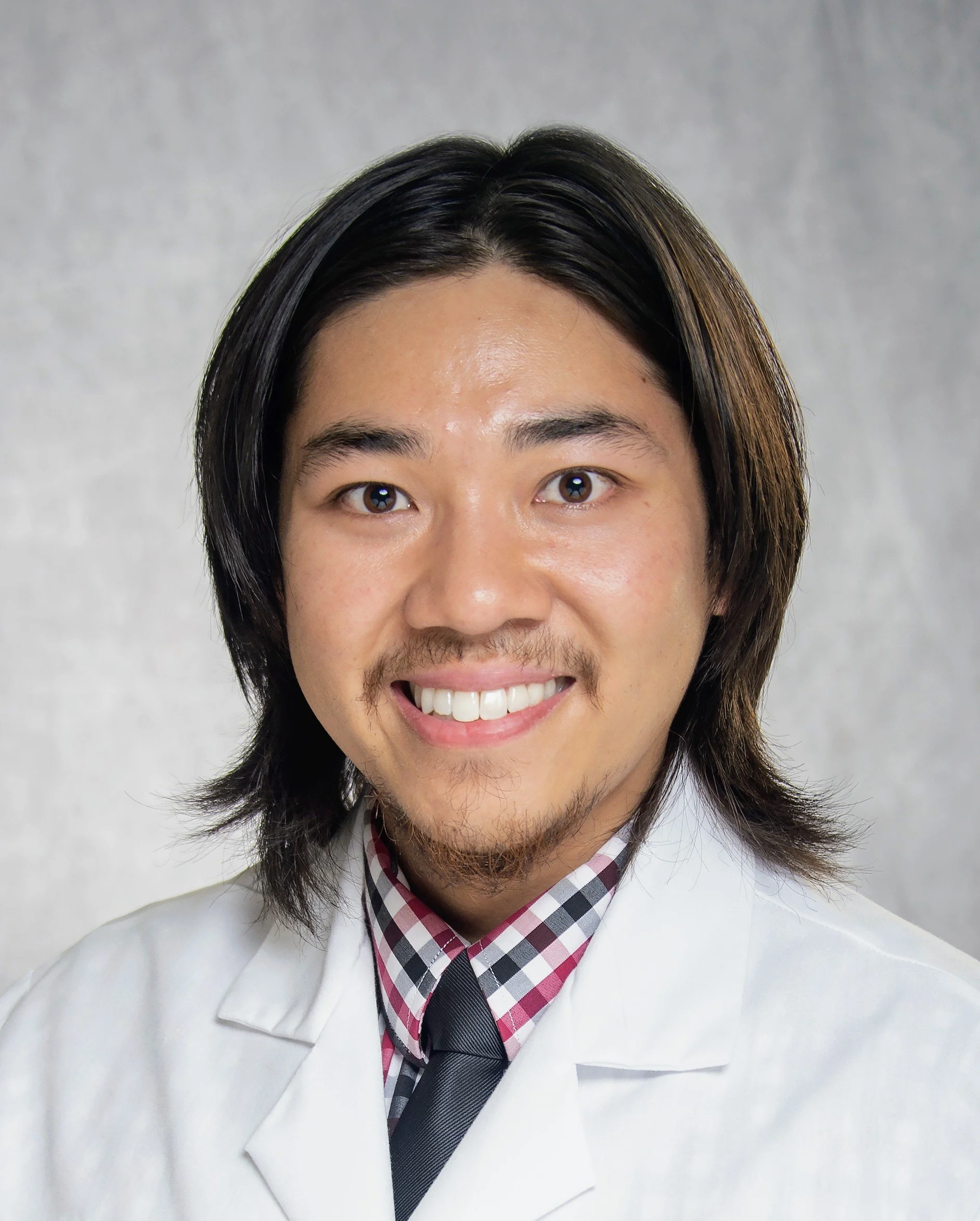 Portrait of Dr. Pichit Thanupakorn, a Christian telehealth psychiatrist and sleep medicine specialist serving North Carolina.