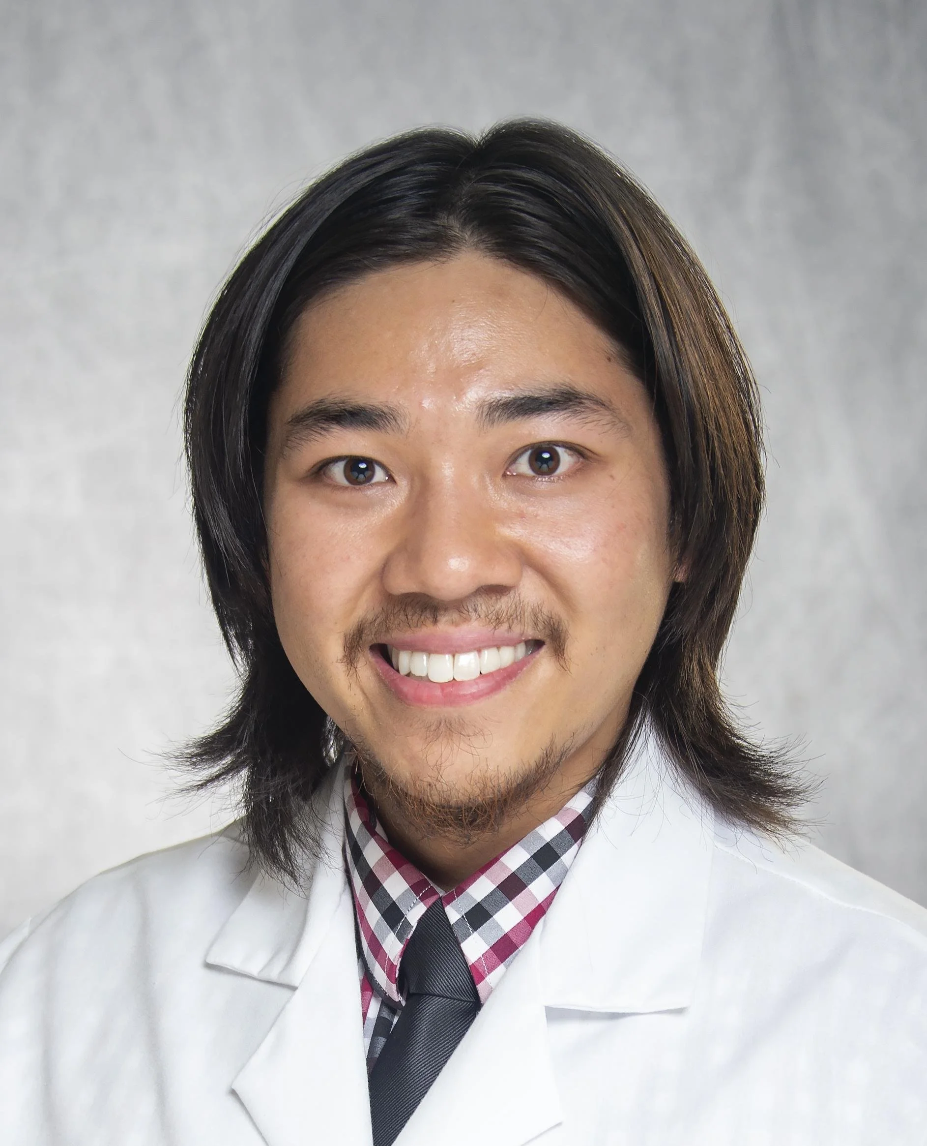 Portrait of Dr. Pichit Thanupakorn, a Christian telehealth psychiatrist and sleep medicine specialist serving North Carolina.