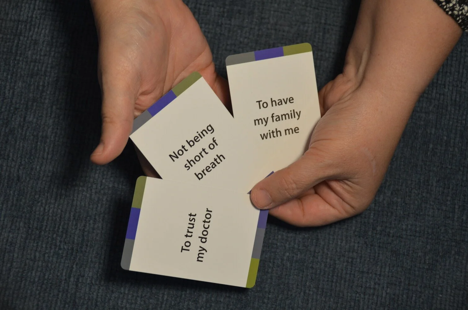 Person holding flashcards with phrases about trust and family