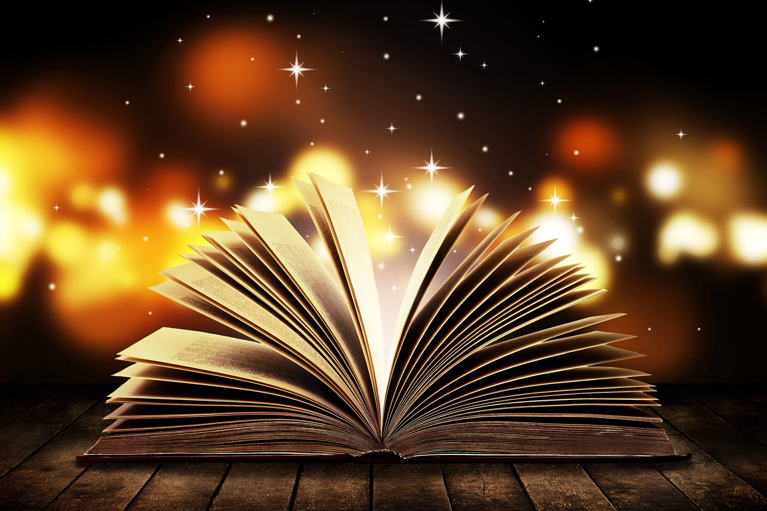 An open book on a dark wooden surface, with glowing light and sparkling stars, creating a magical, cosmic atmosphere.