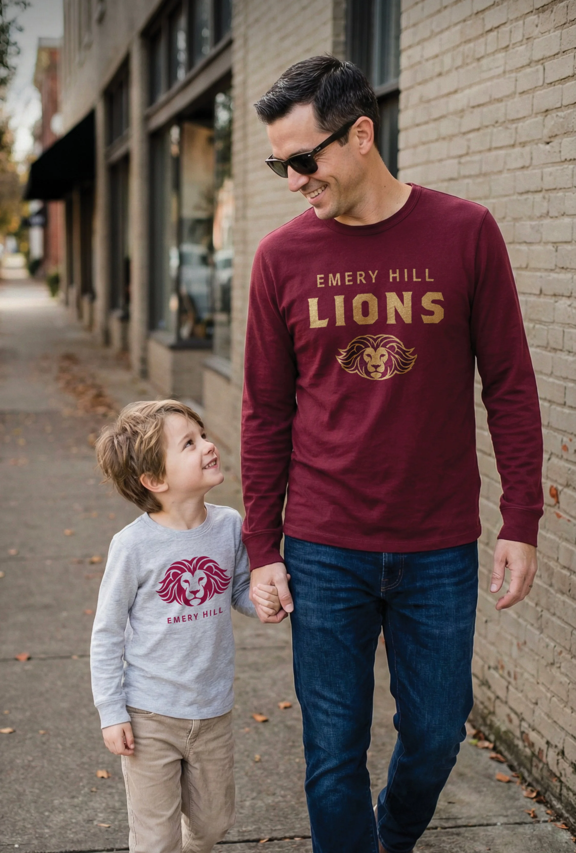 Dad and son wearing matching custom promotional long‑sleeve t‑shirts from JQ Promo in South Elgin.