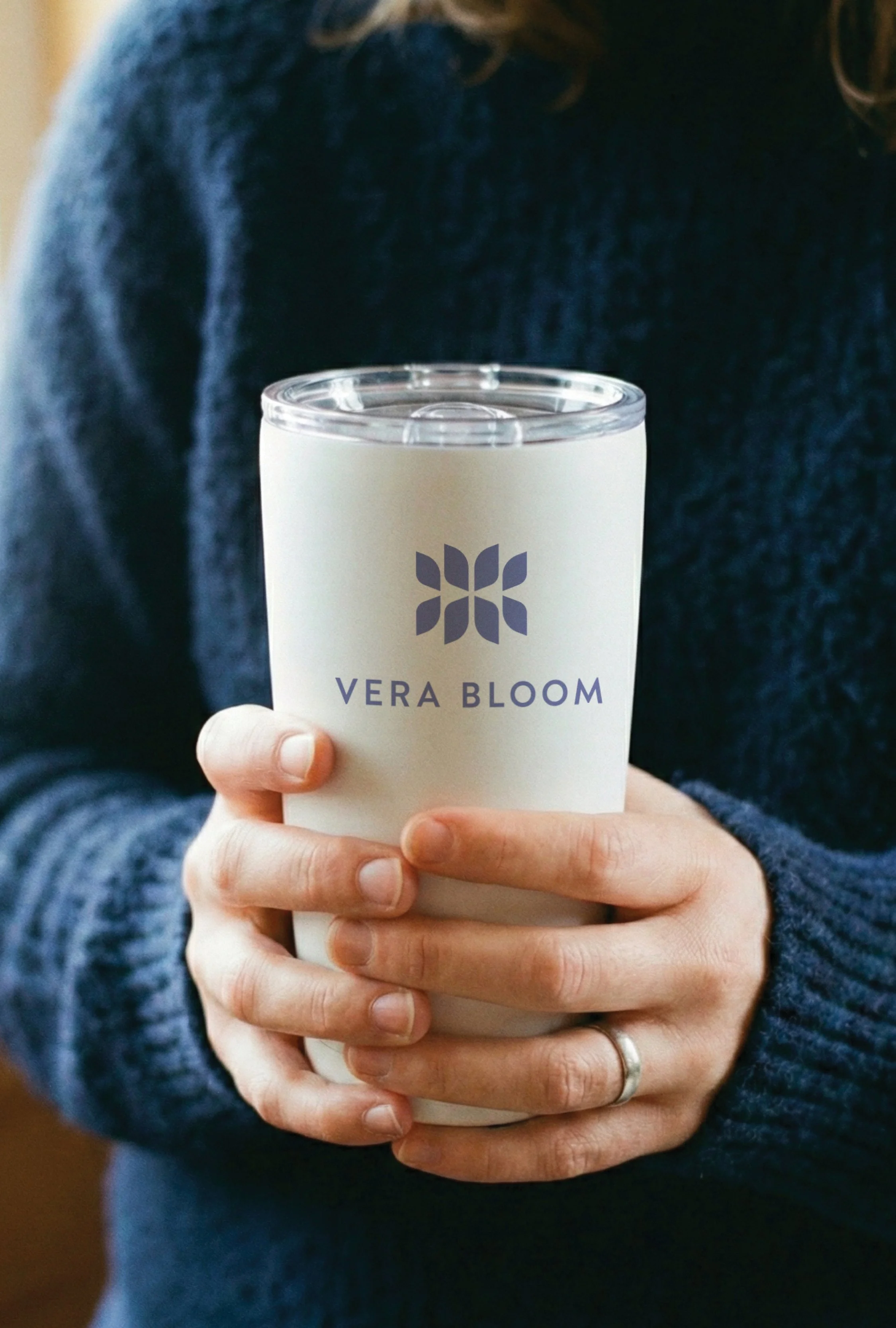 Person holding a custom promotional coffee tumbler branded by JQ Promo.