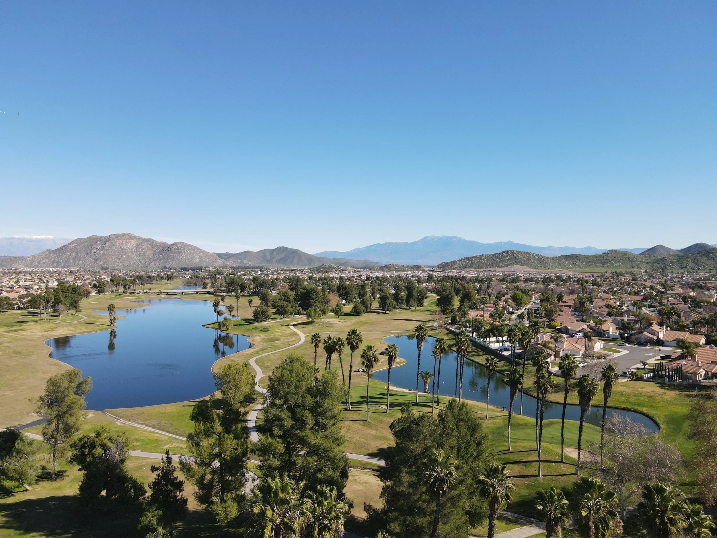 Aerial photograph of Menifee Lakes Country Club Lake Course with mountain scenery and two lakes