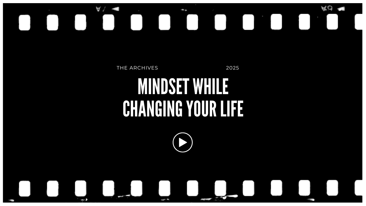 Black background with white text reading "Mindset While Changing Your Life" and smaller text saying "The Archives 2025" with a play button icon in the center.