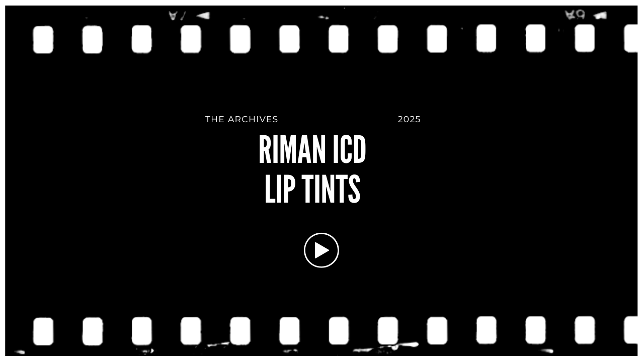 Screen displaying a website with a black background, film strip borders, and white text that says 'The Archives 2025', 'Riman ICD Lip Tints', with a play button below.