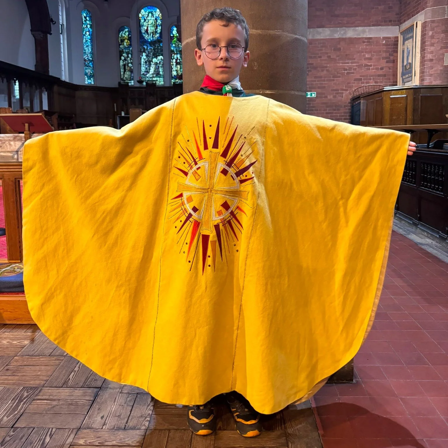 Our Cubs are currently exploring different places of worship as part of their Faith Badge, and we loved welcoming them to St George's.

Here's one of them trying on a chasuble &ndash; the outer robe worn by the priest when presiding at the Eucharist 