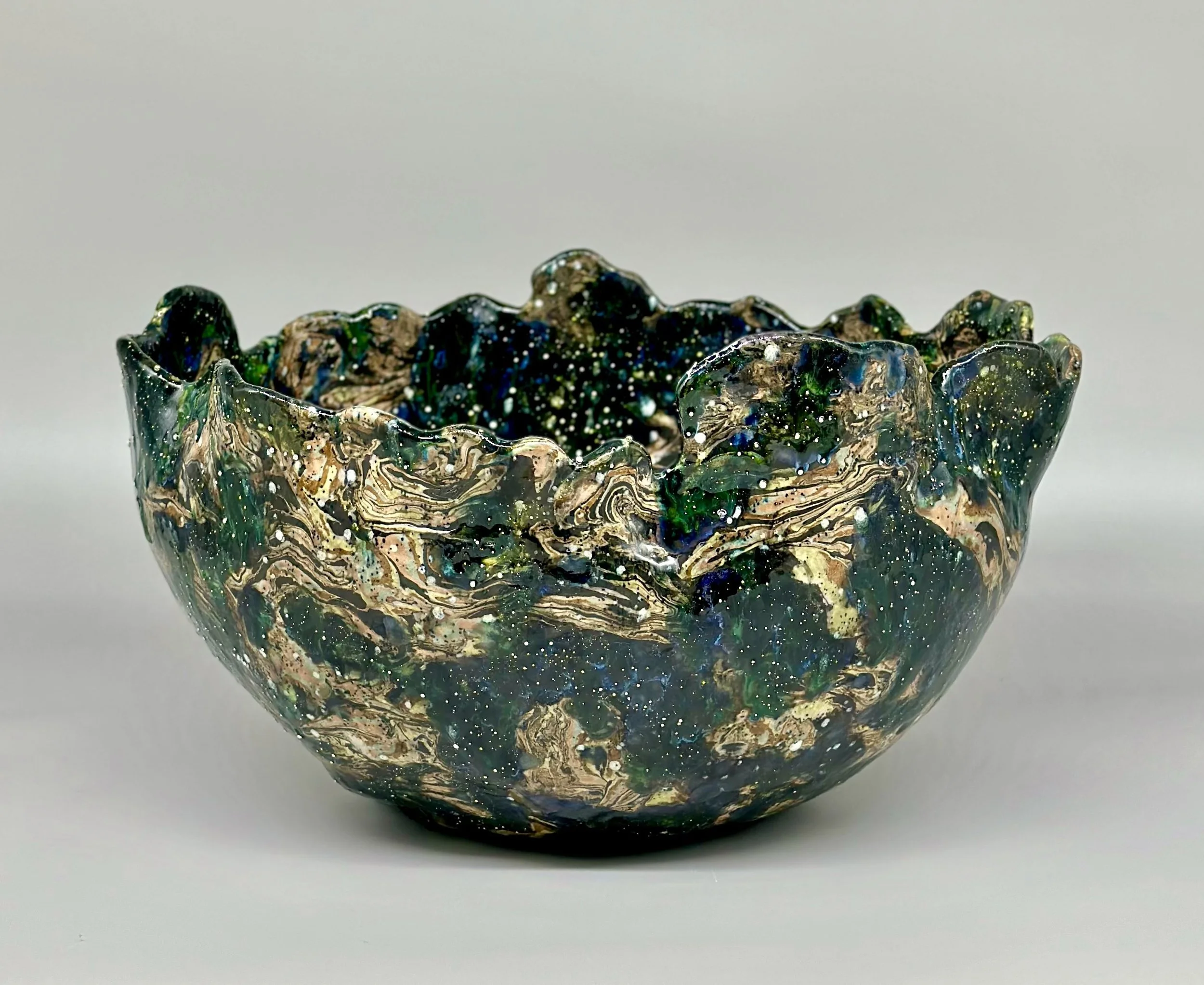 * Title: uNtItLeD_VIII_a, 2024
* Medium: black porcelain, blue, orange, yellow and pink pigments, stonewares, crystal Glaze, grey mother of pearl, and silver luster overglaze
* Size: 7.5” x 13” x 13”
