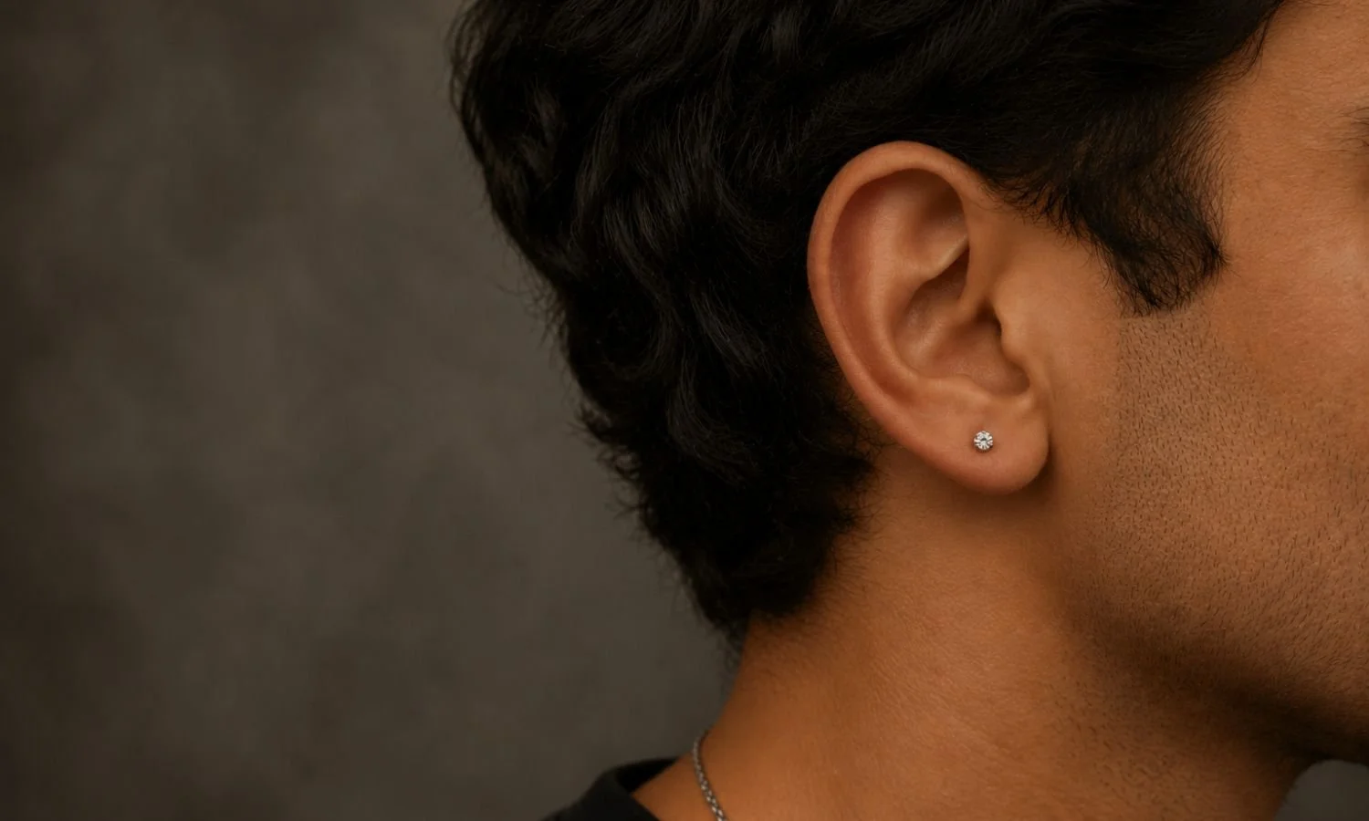 Single lobe ear piercing with a simple stud, ideal for first-time piercing clients.