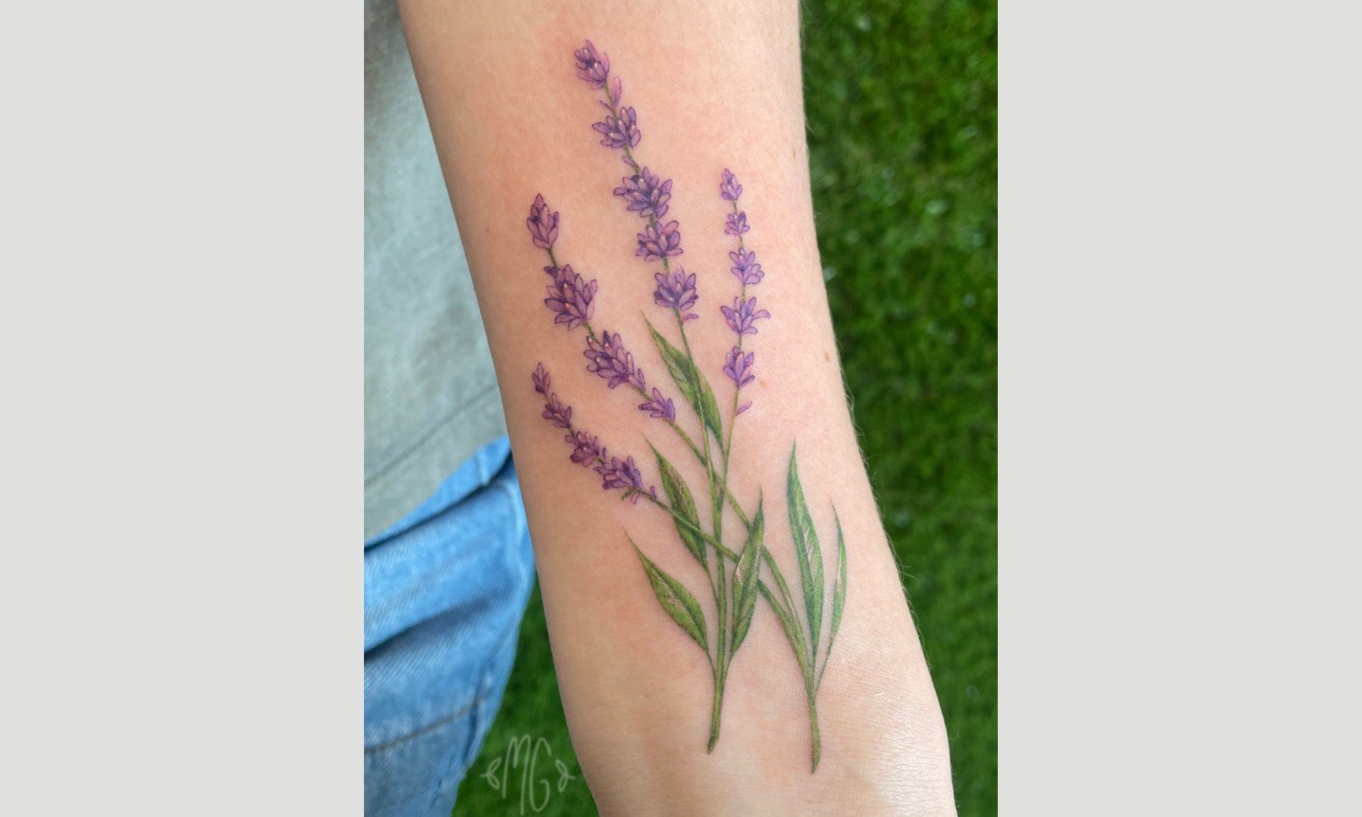 Fine line lavender tattoo on forearm showing delicate detail and minimal shading in San Antonio.
