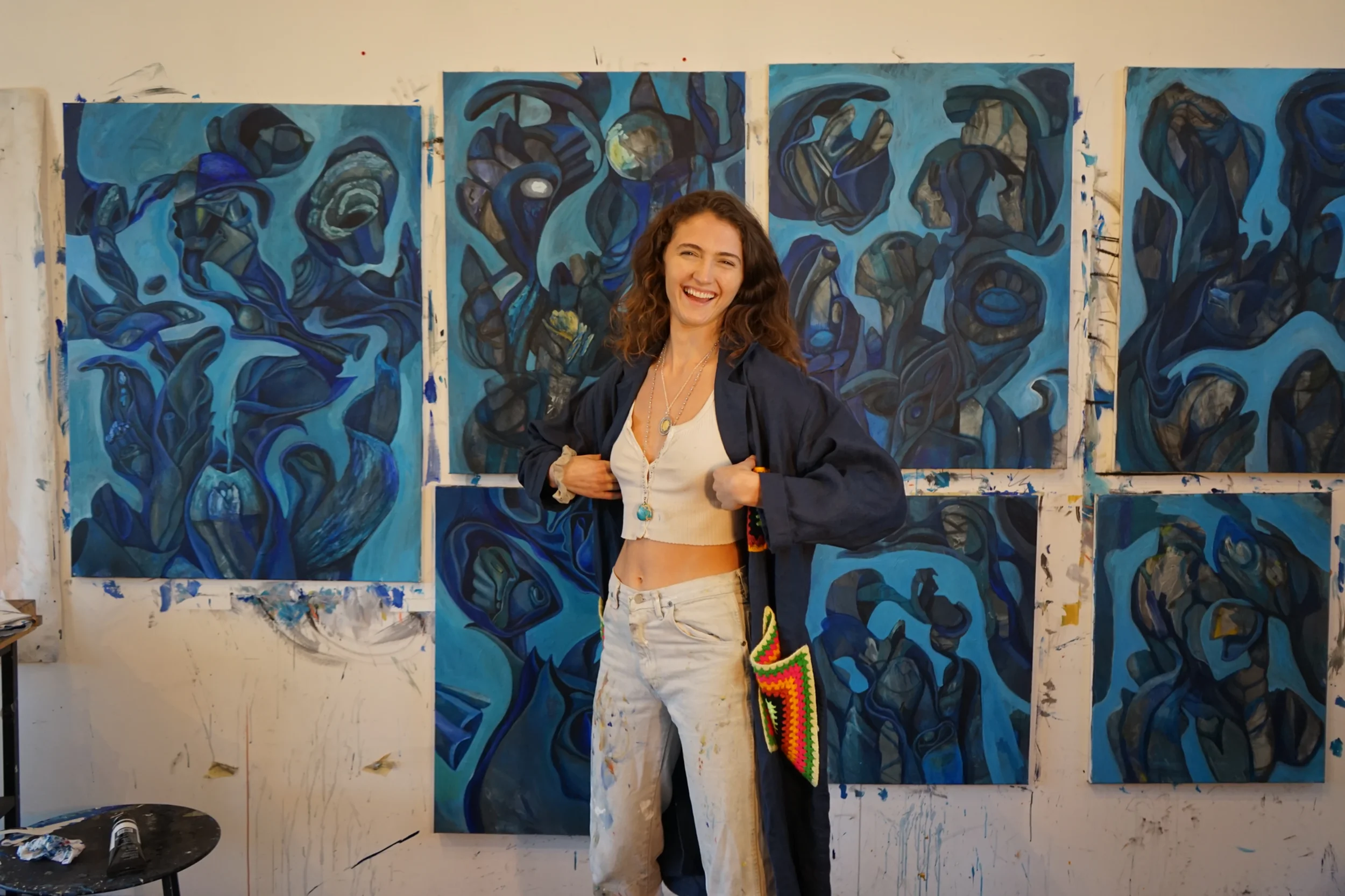 blue paintings and zoe rose the artist smiling.webp