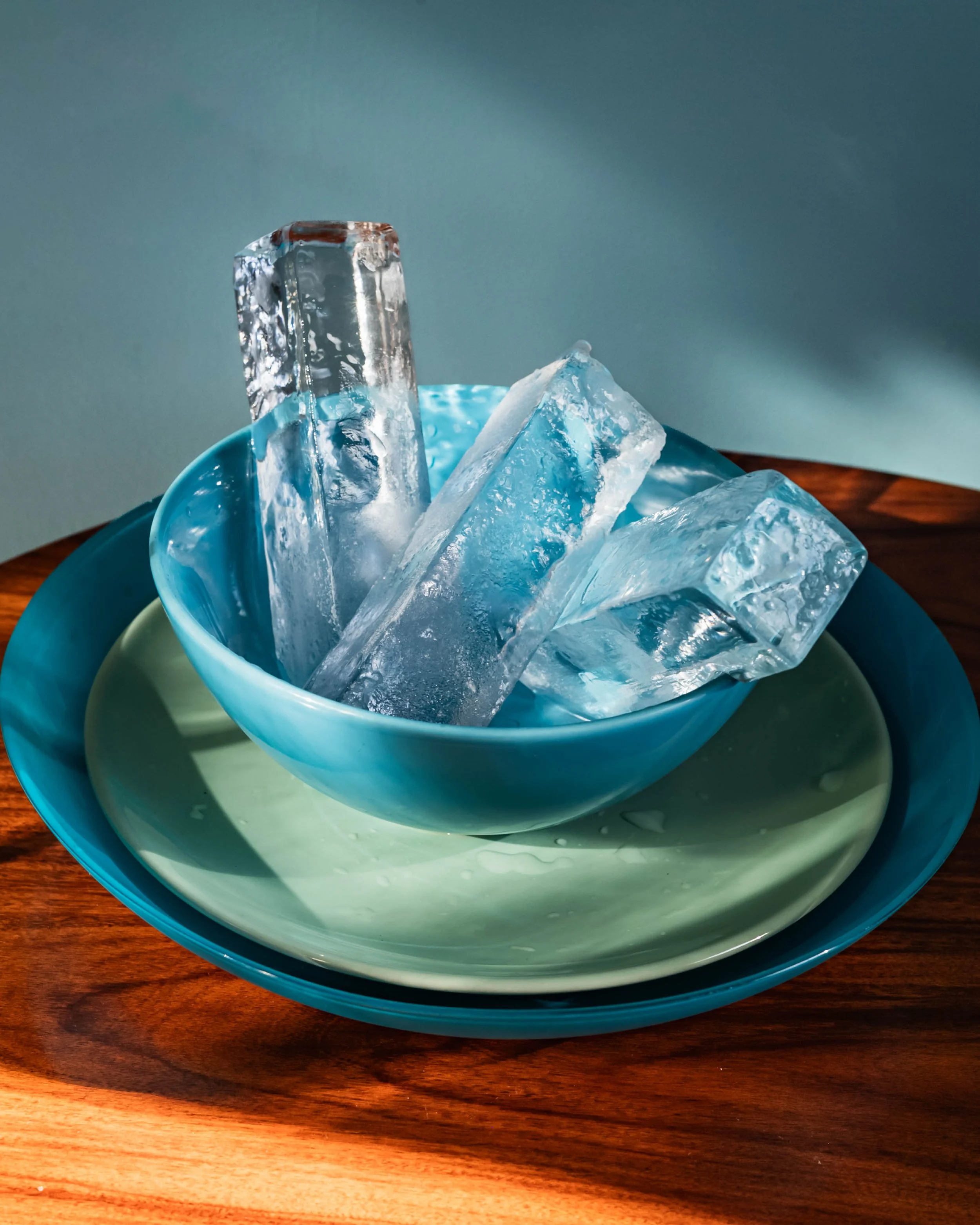 craft artisanal cocktail ice cube spears in a blue bowl