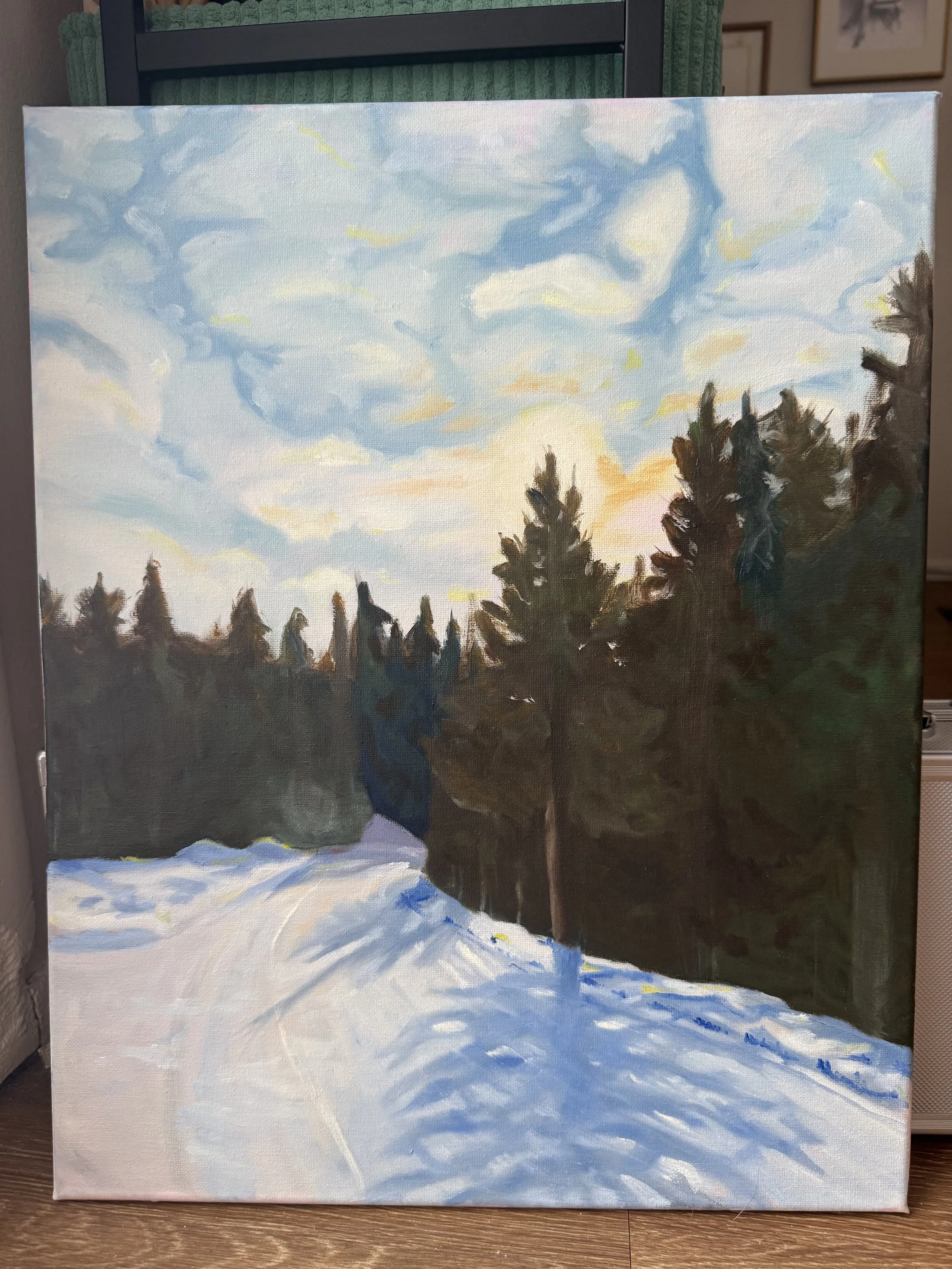 An oil painting of a winter landscape with snow-covered ground, evergreen trees, and a sky with clouds and the sun setting.