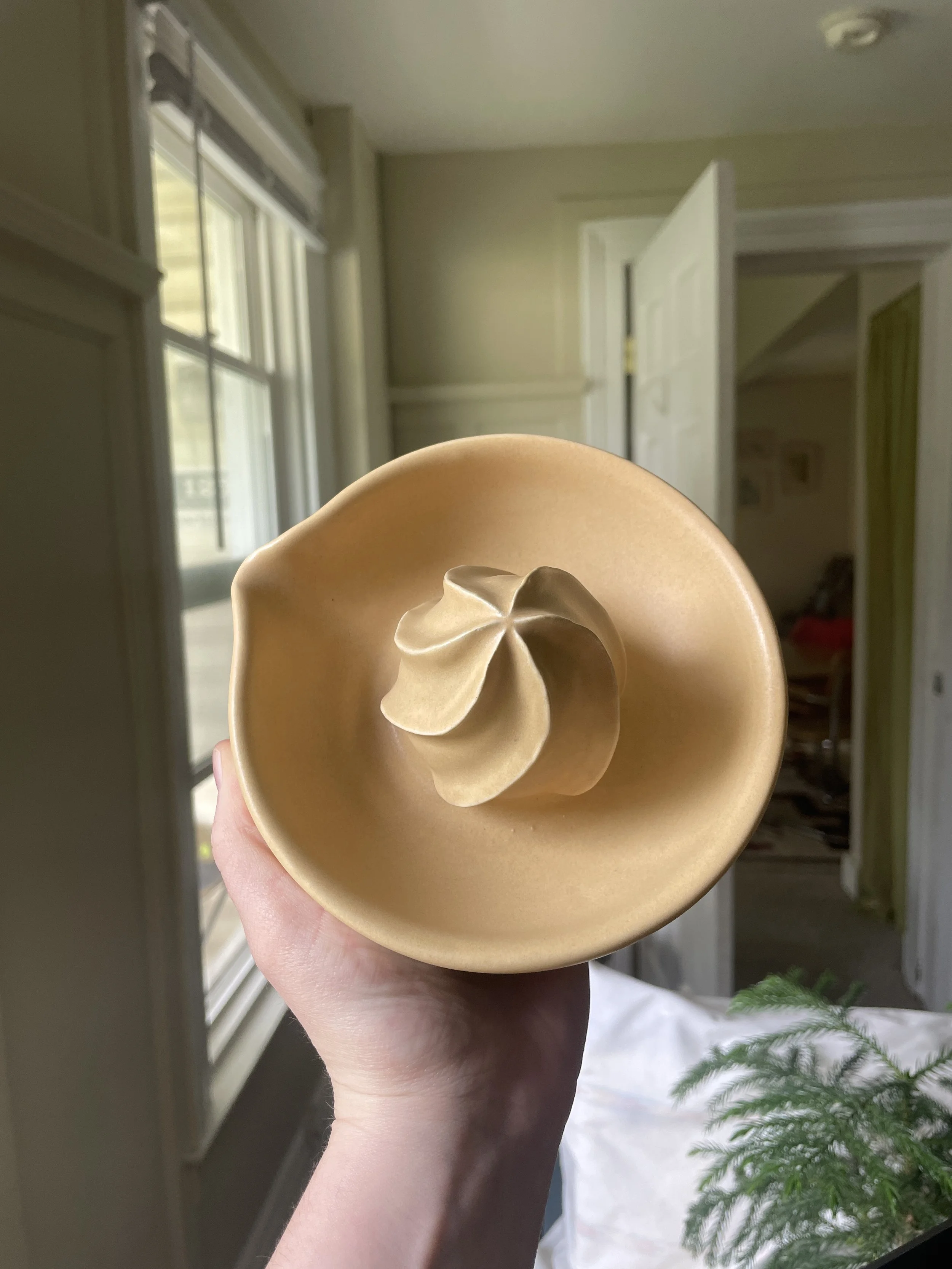 A beige ceramic citrus juicer.