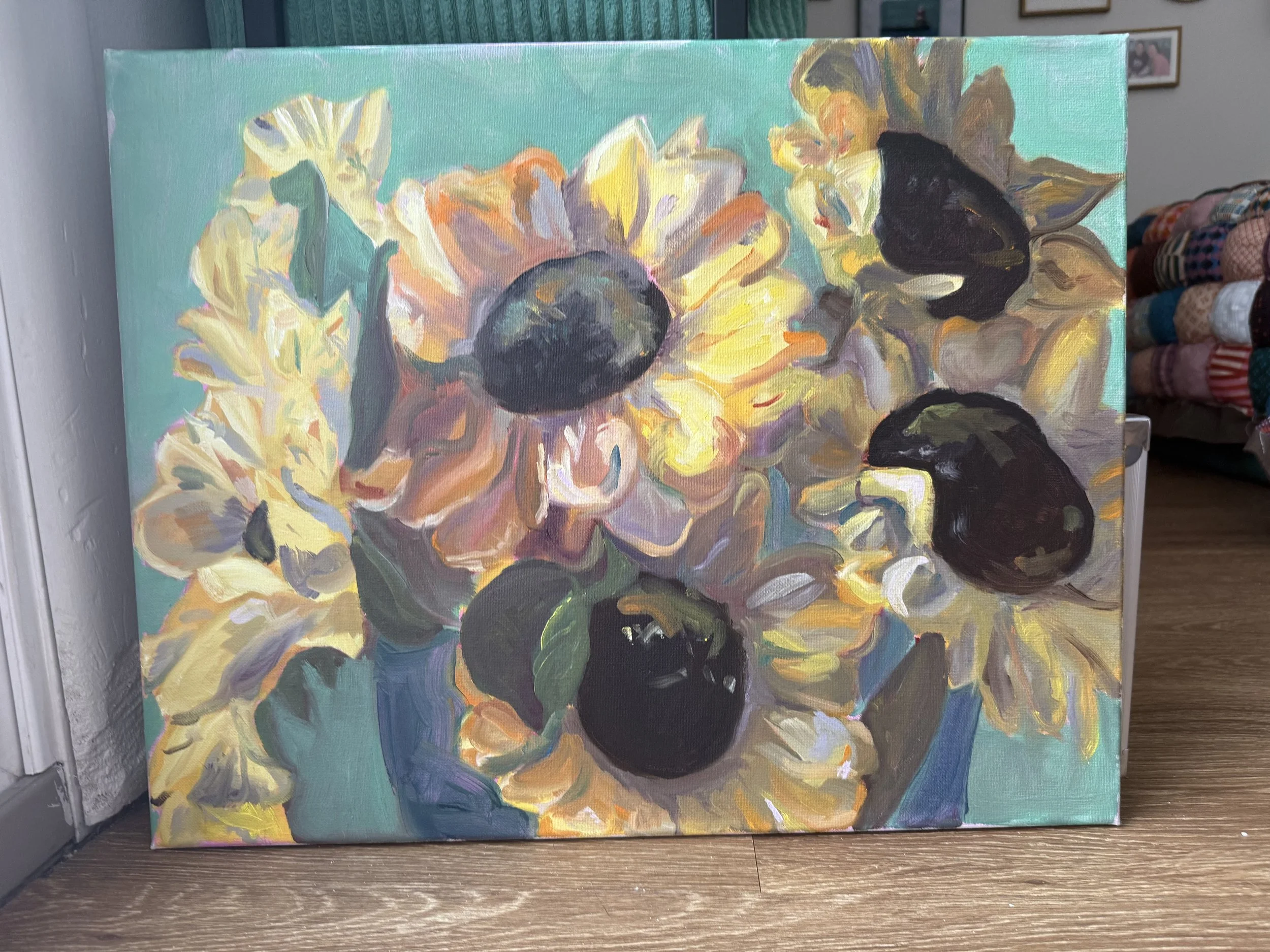 Painting of sunflowers on a teal background.