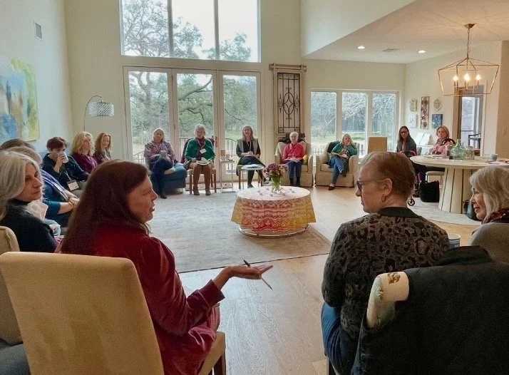 Group of women sitting around in a circle discussing something.