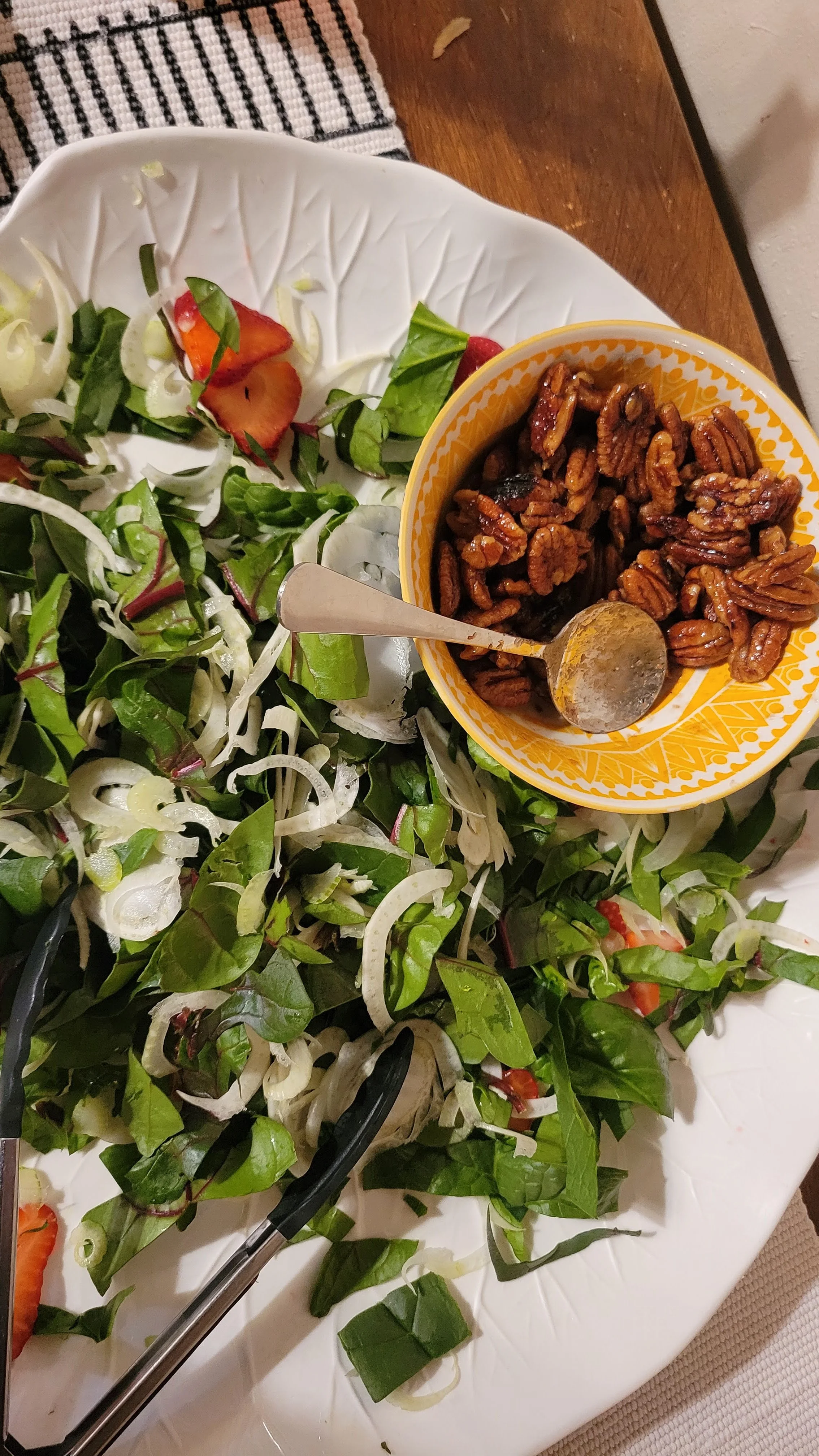 Culinary shots of arugula salad dressed with candied walnuts.