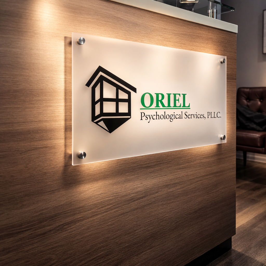 Signboard for Oriel Psychological Services, PLLC, mounted on a wooden wall in an office setting.