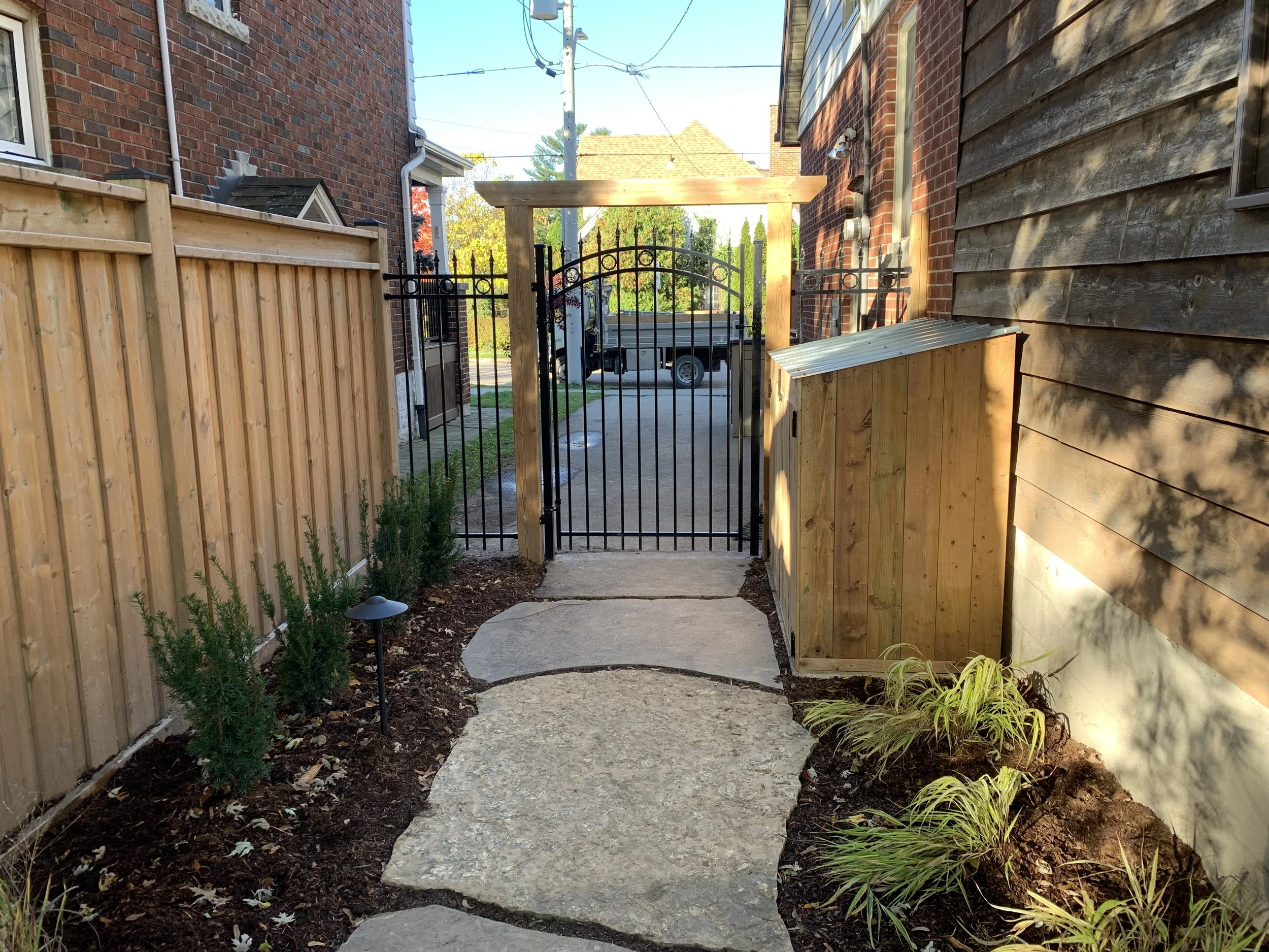 Fence - wrought iron gate, flagstone walkway.jpeg