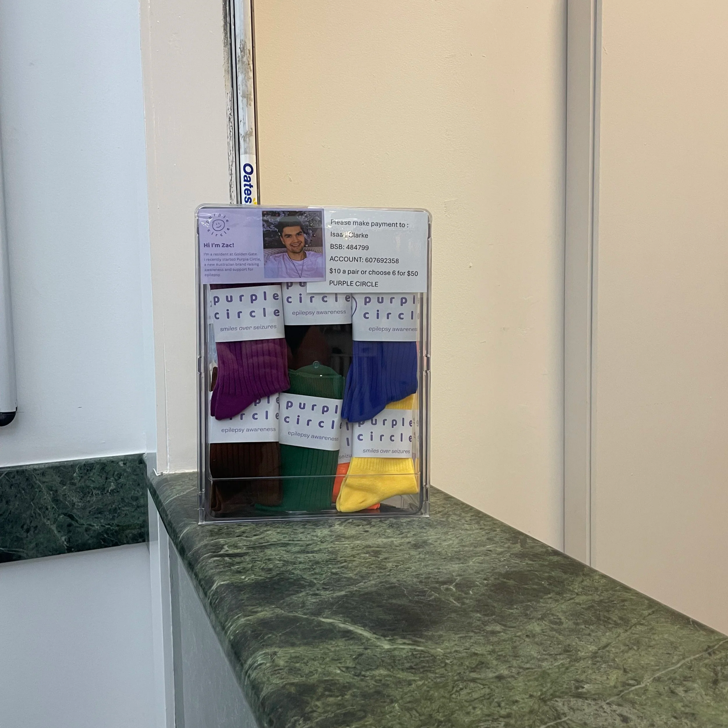 Display stand for Purple Circle Socks at a hotel reception. Epliepsy awareness