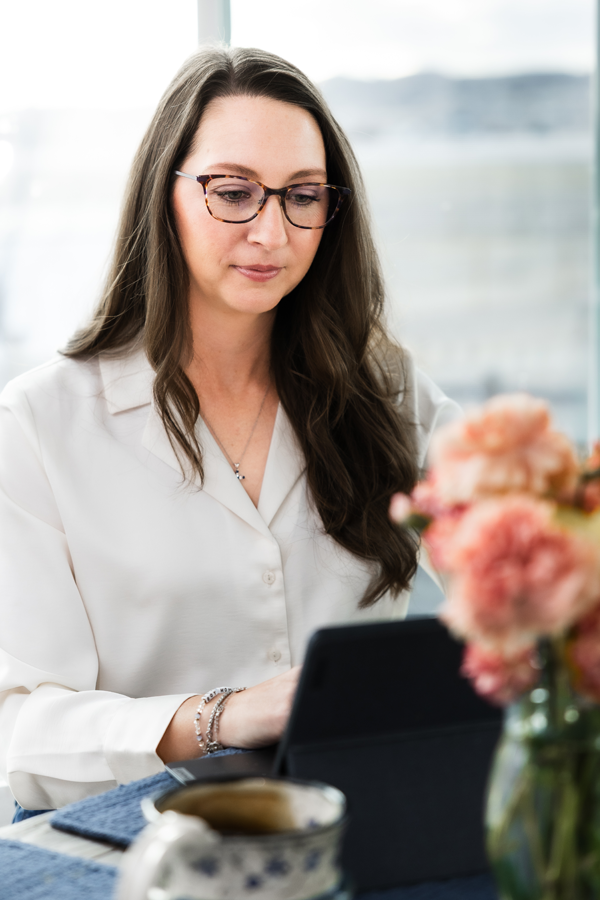 Jenn Baas looking down at laptop, working