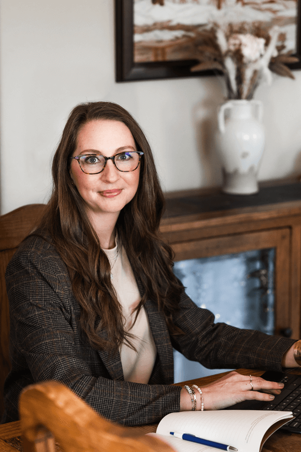 Jenn Baas sitting at wood table