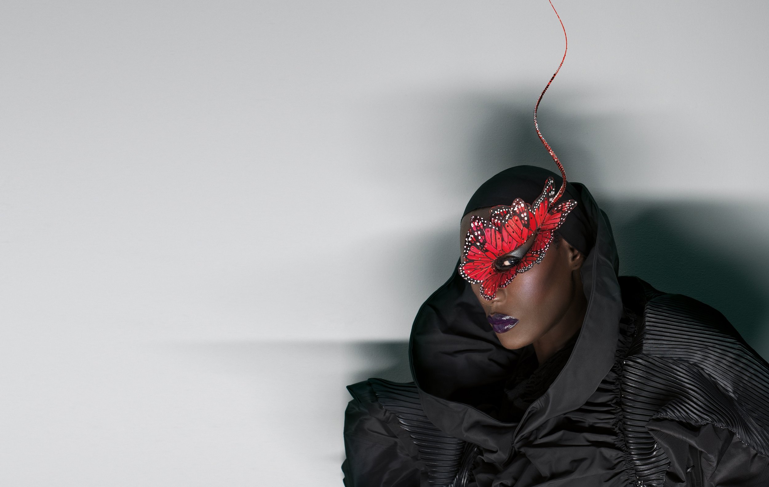Grace Jones with a butterfly mask. Photographer Andrea Klarin