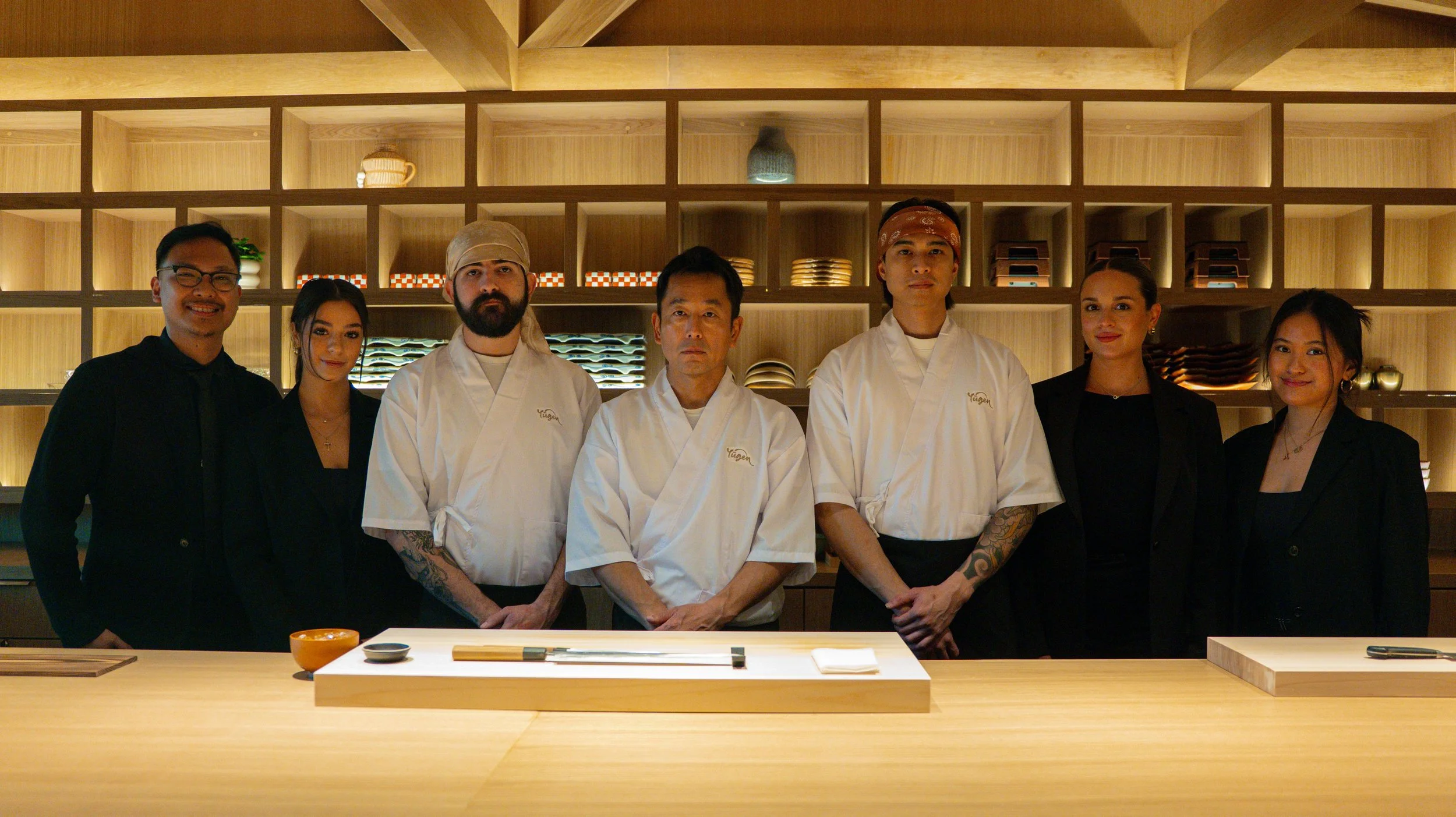 The complete Yugen Sarasota culinary and service team posed at the 10-seat omakase counter.