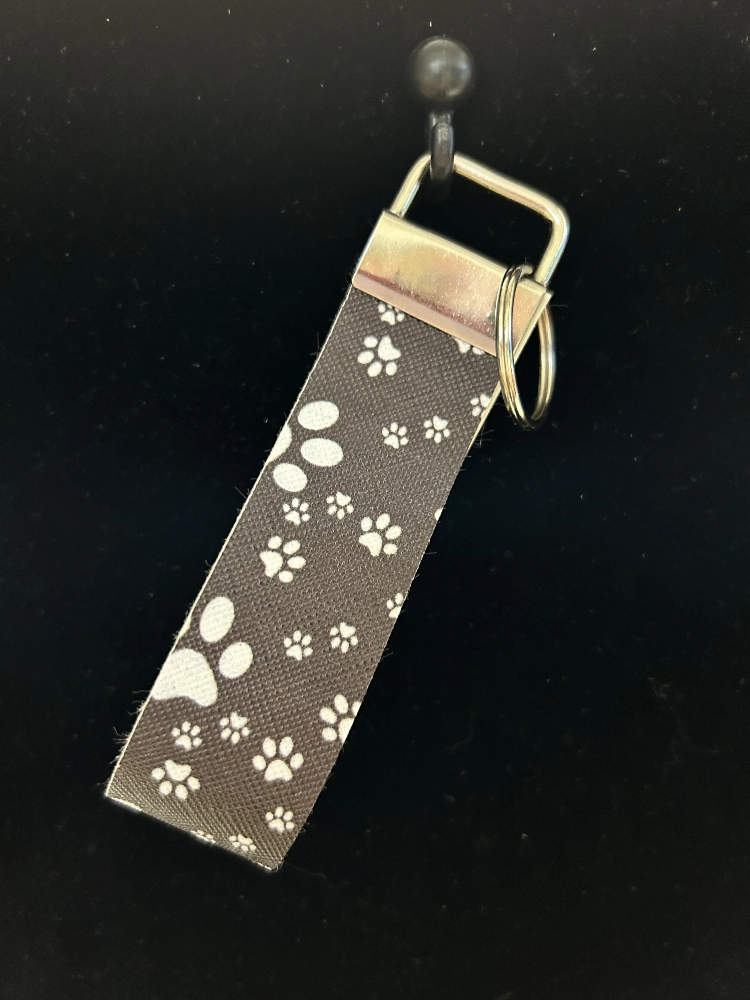 Puppy paw black hand held