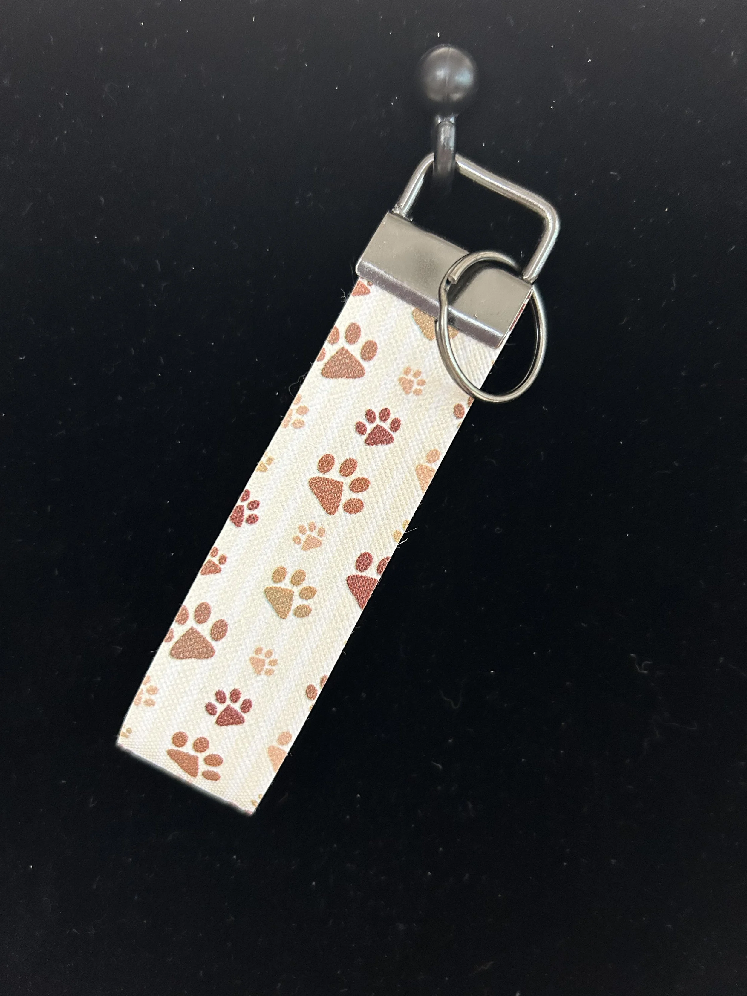 Puppy paw white beige and brown hand held