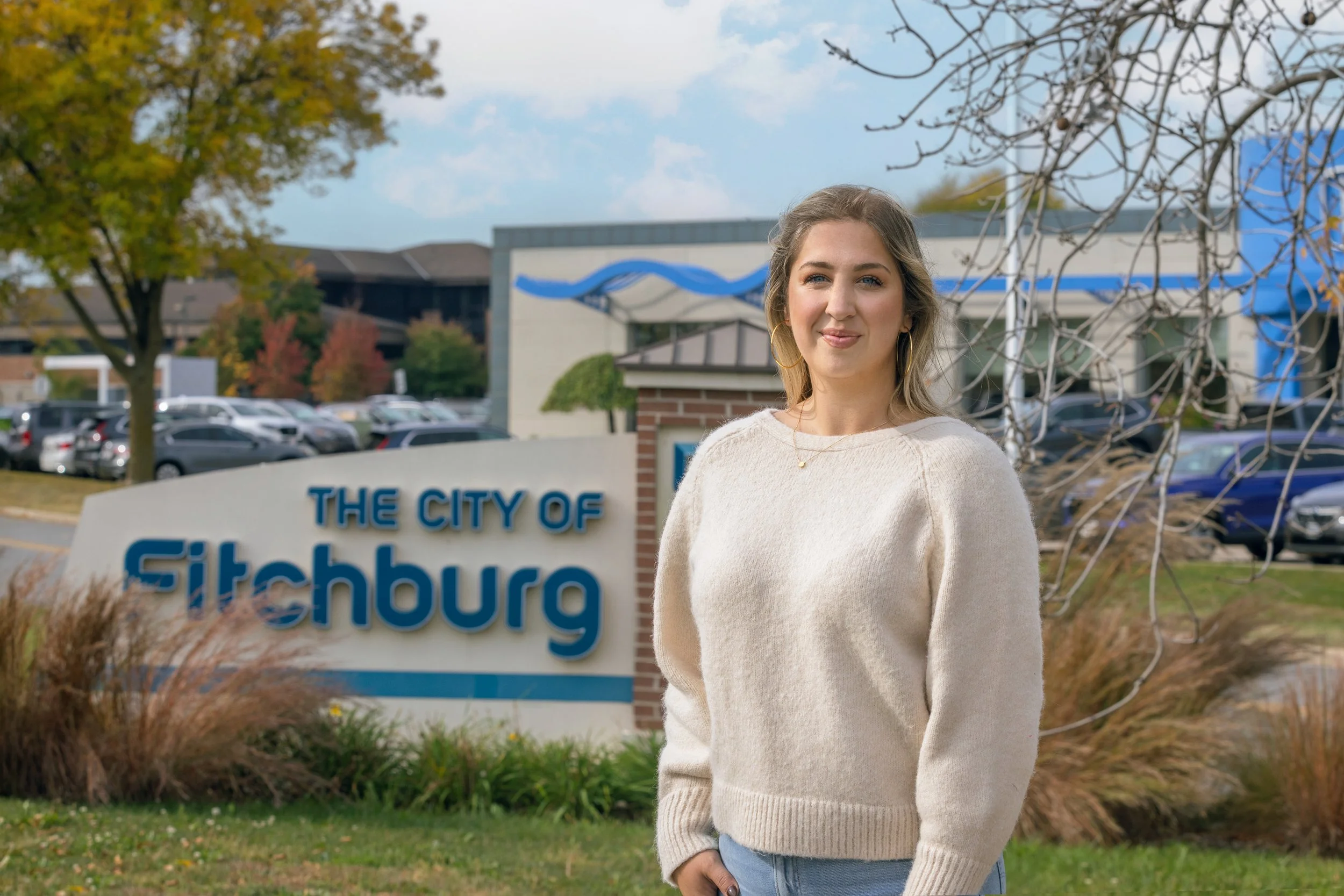 Victoria LaBrosse standing in front of the City of Fitchburg welcome sign