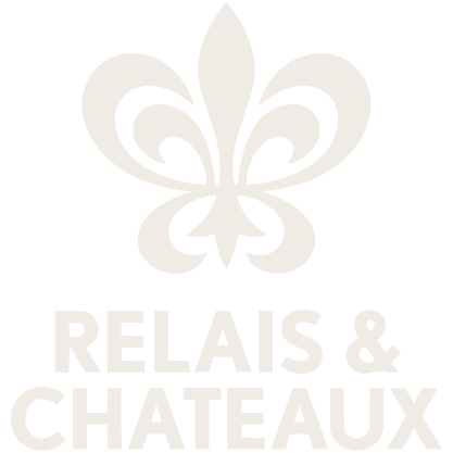 A white fleur-de-lis symbol above the text 'RELAIS & CHATEAUX' on a black background.