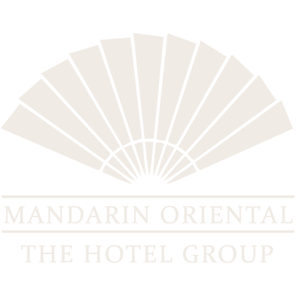 Logo for Mandarin Oriental Hotel Group featuring an abstract fan design and the company name