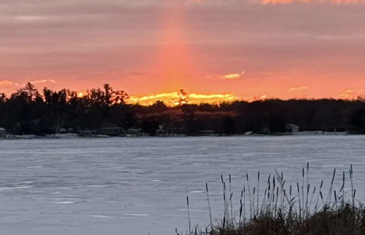Sun rising over round Lake Nisswa, Minnesota