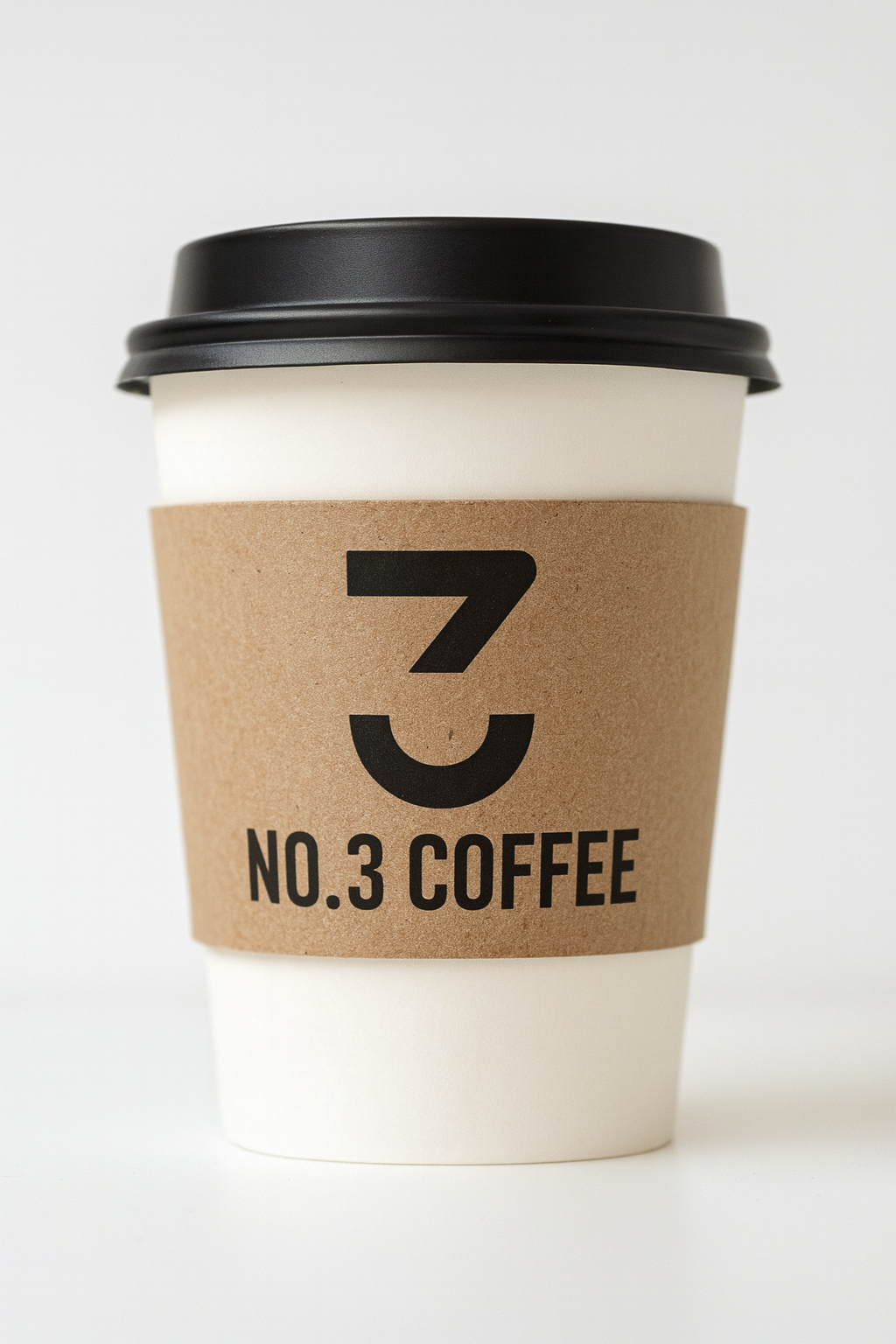 A white takeout coffee cup with a black plastic lid, wrapped in a brown paper sleeve labeled "No. 3 Coffee" with a large stylized number 3.