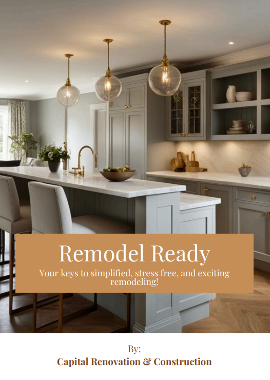 Modern kitchen with white cabinets, marble countertops, three pendant lights, and open shelving. There are chairs at the counter and a bowl of fruit on the island.