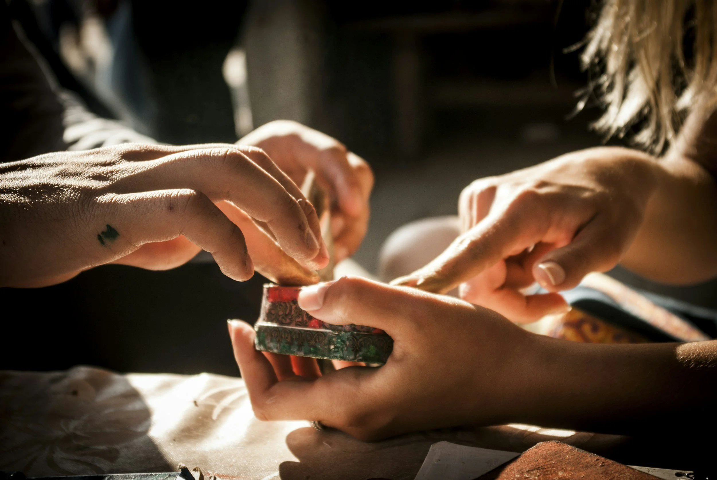 two women hands collaborating on a craft activity