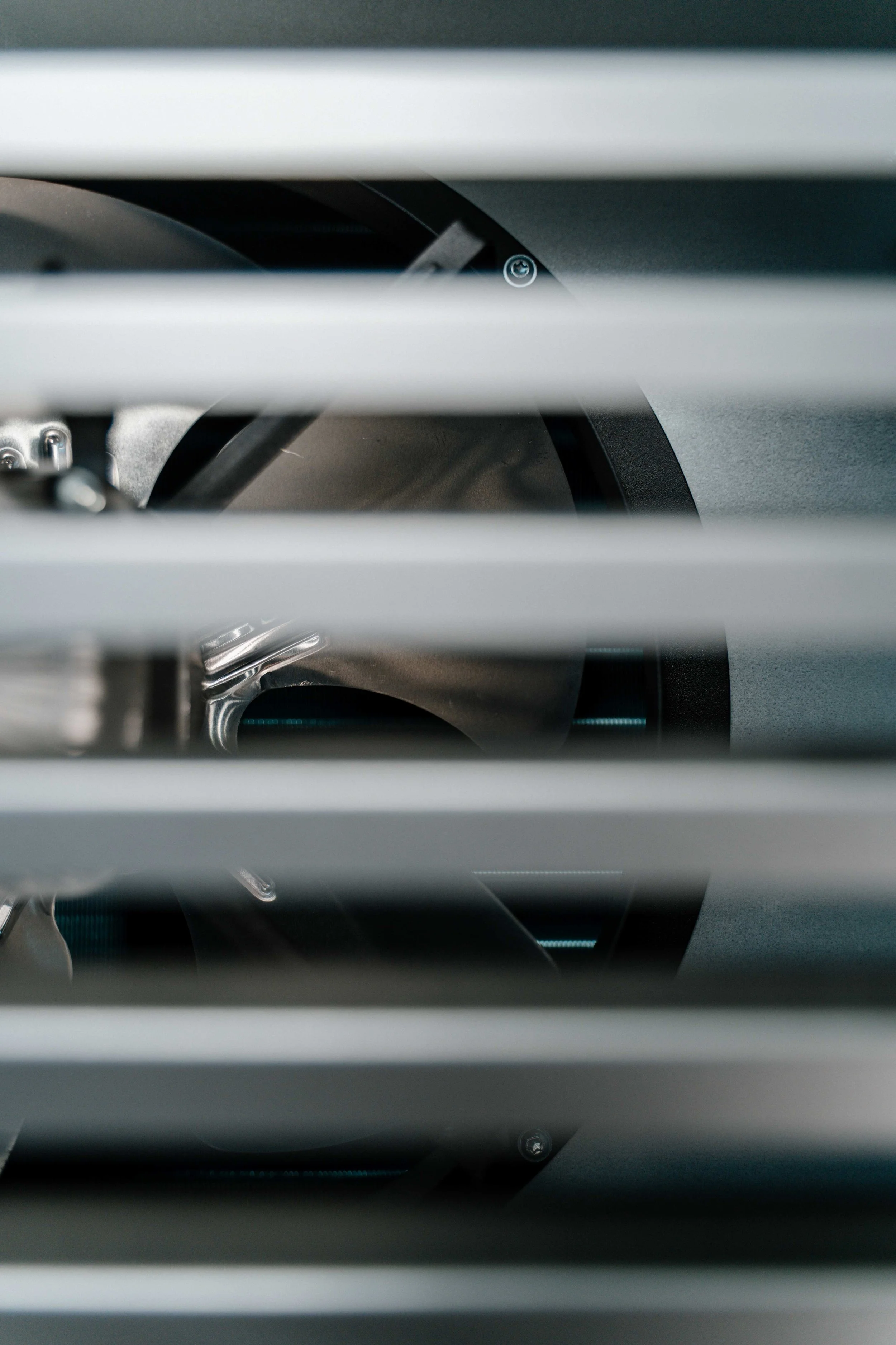 Close-up view of a dehumidifier's fan blades behind horizontal vents.