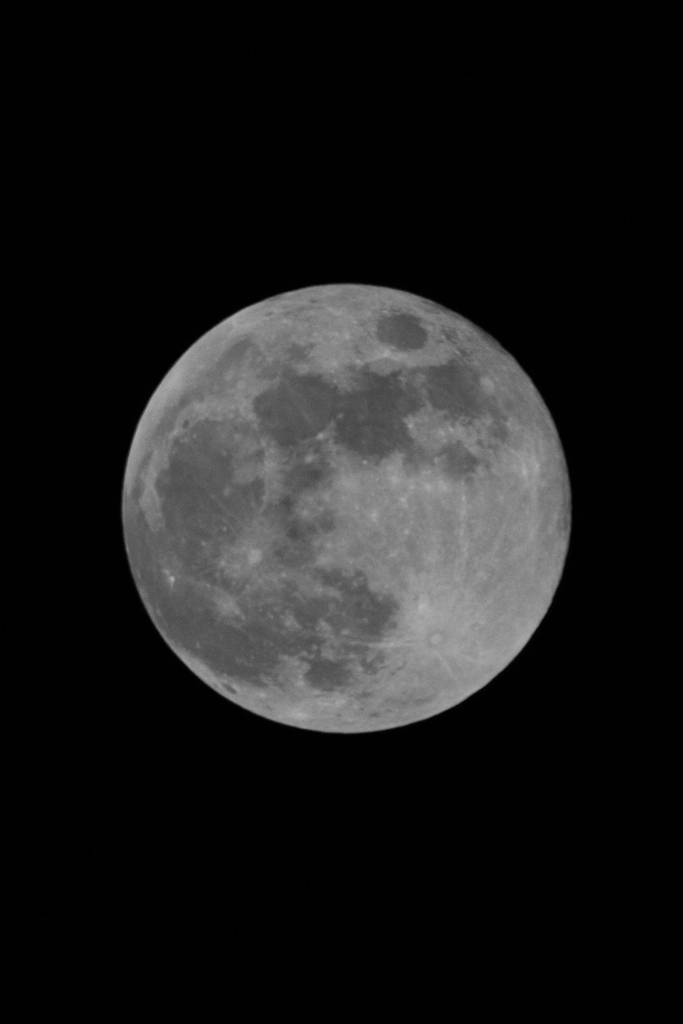 A detailed photograph of the full moon against a dark night sky.
