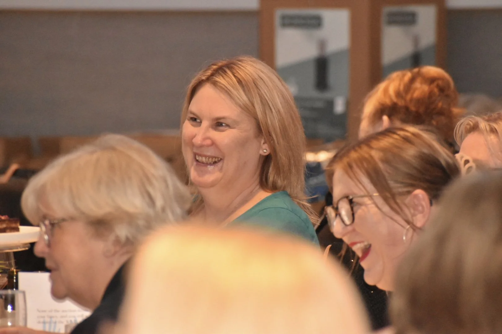 A group of women enjoying a moment of laughter at a social gathering or event.
