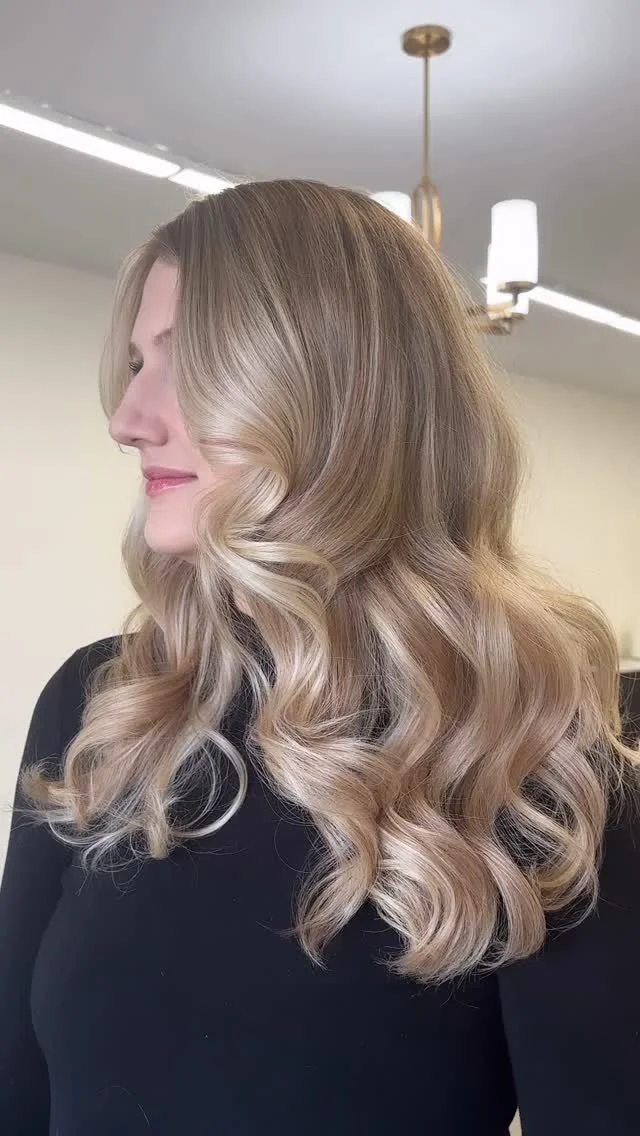 Long hair styled with soft waves at Thistle & Co