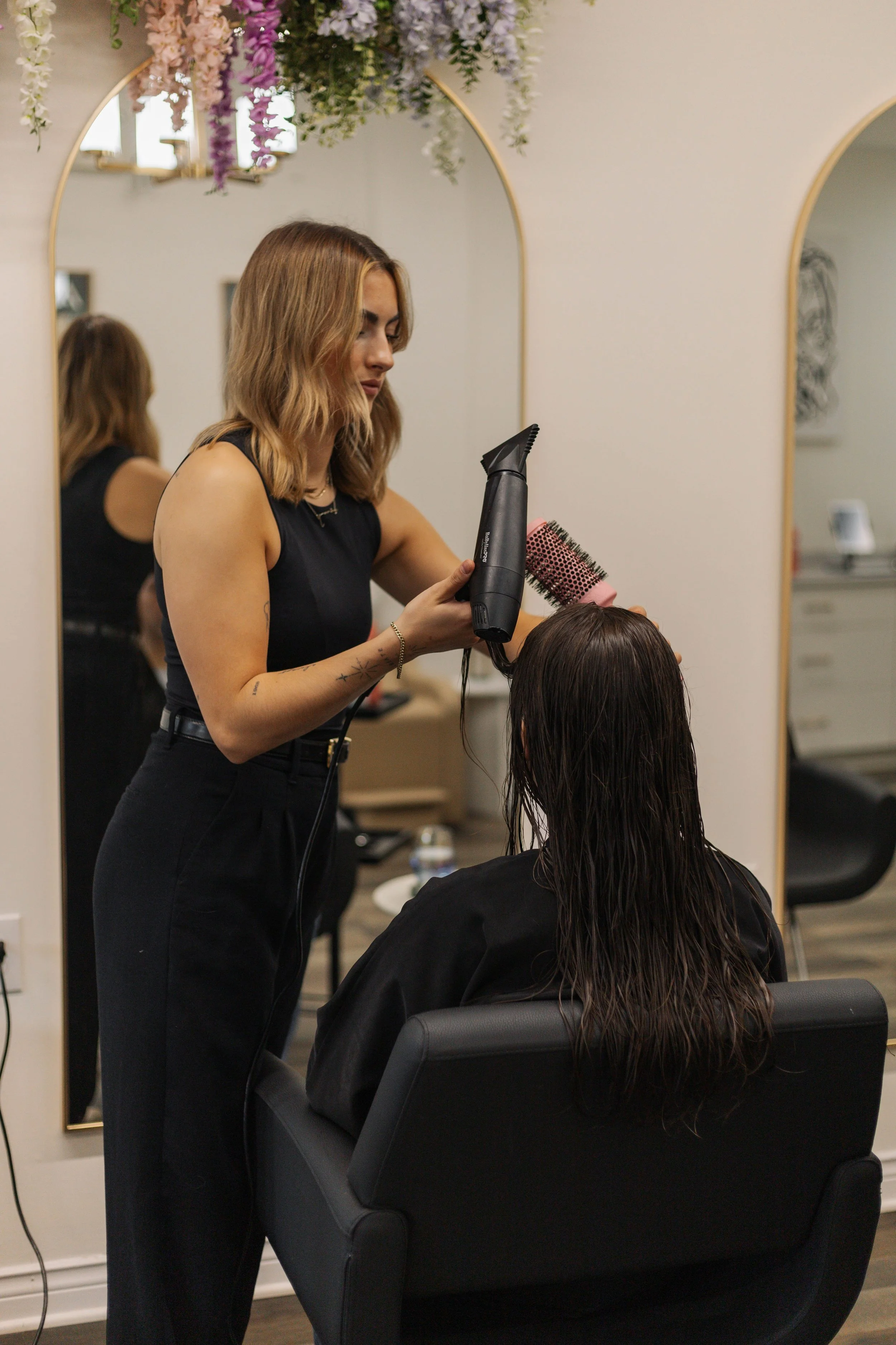 Stylist performing precision haircut at Thistle & Co in St. John’s