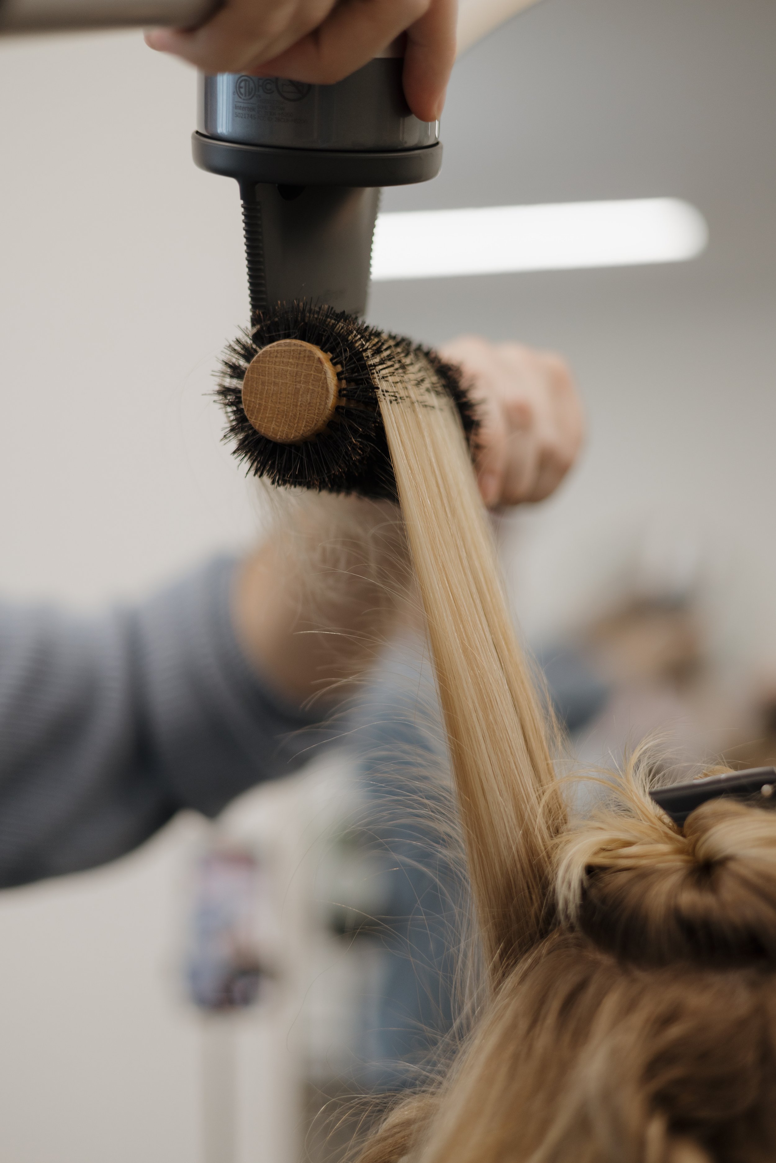 Hair stylist consulting with client at Thistle & Co salon