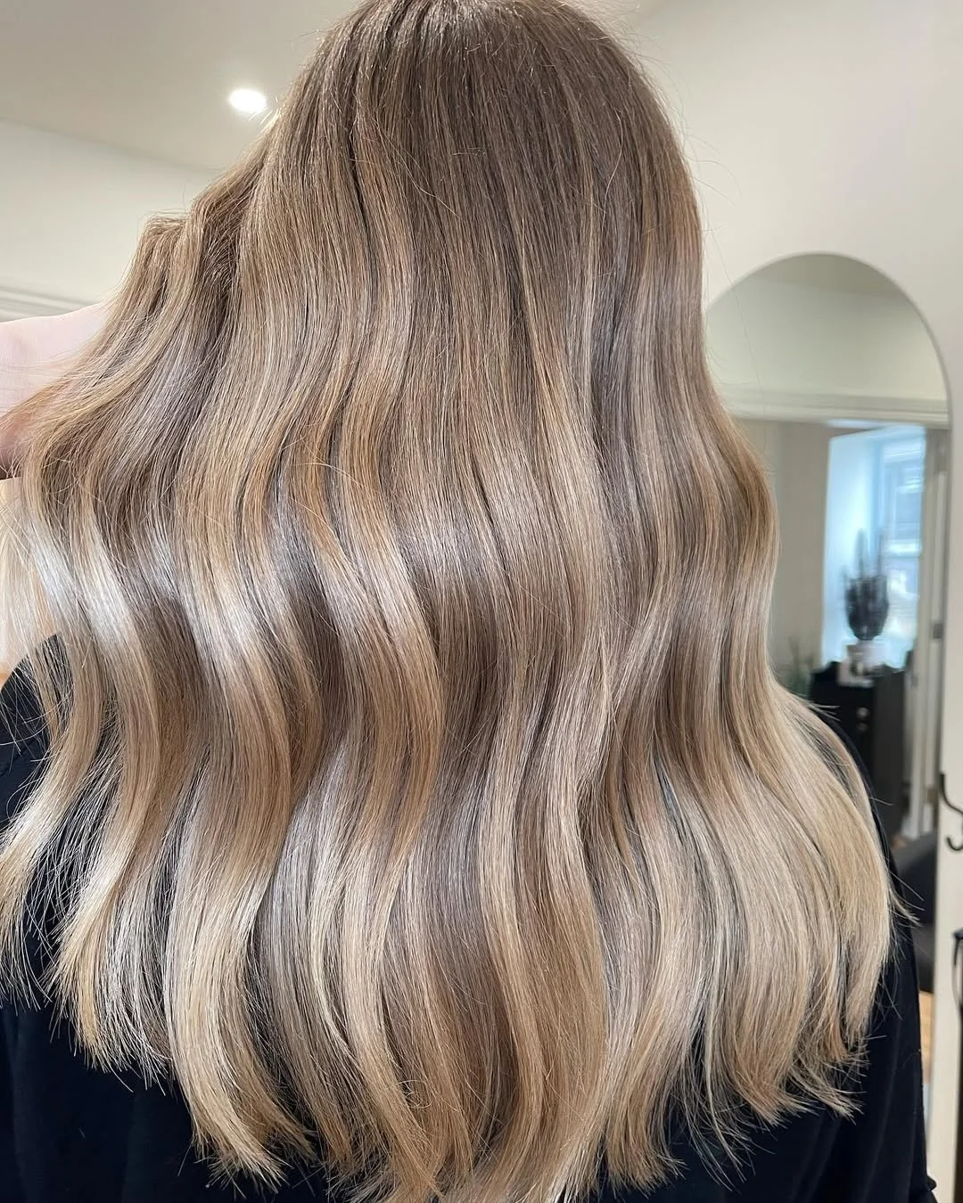 Soft balayage highlights on blonde hair at Thistle & Co