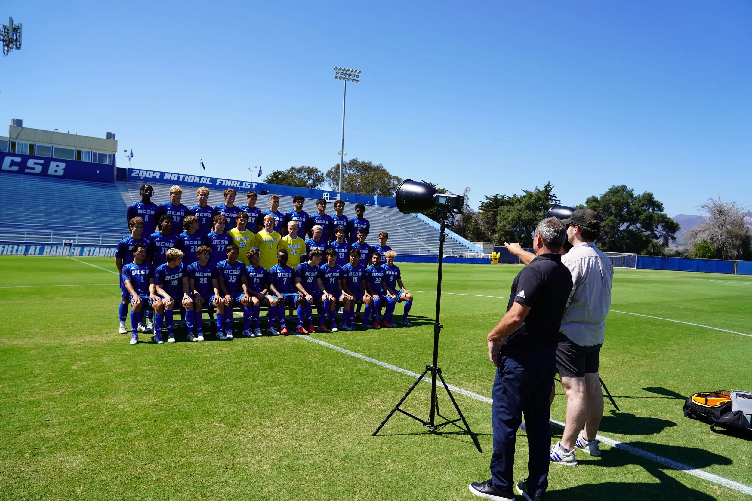 Behind the scenes of team photo at Harder Stadium, documenting the setup and candid moments that shape the final shot.