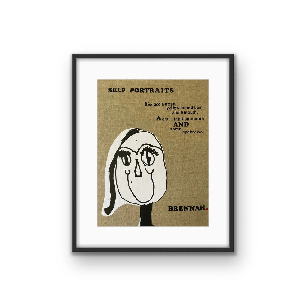 Framed artwork featuring a simple, abstract self-portrait drawing of a face with expressive eyes, a large nose, and long hair, accompanied by text about self-portraits, with the name Brennah at the bottom right.